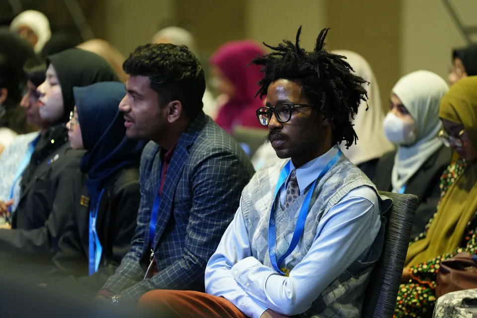 Audience members listening at a conference